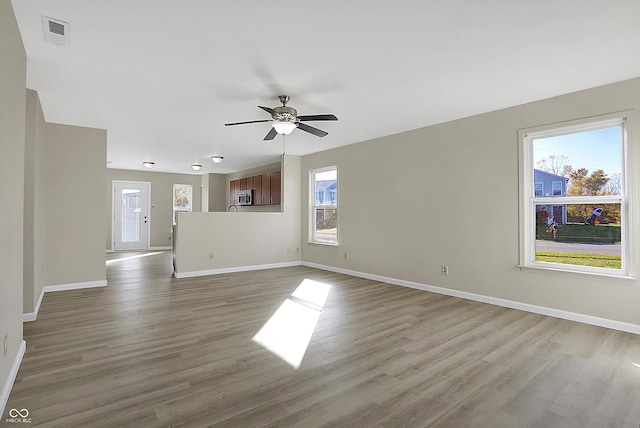 unfurnished room with ceiling fan and hardwood / wood-style flooring