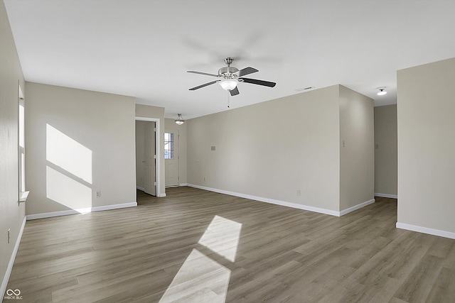 spare room featuring light wood-type flooring and ceiling fan