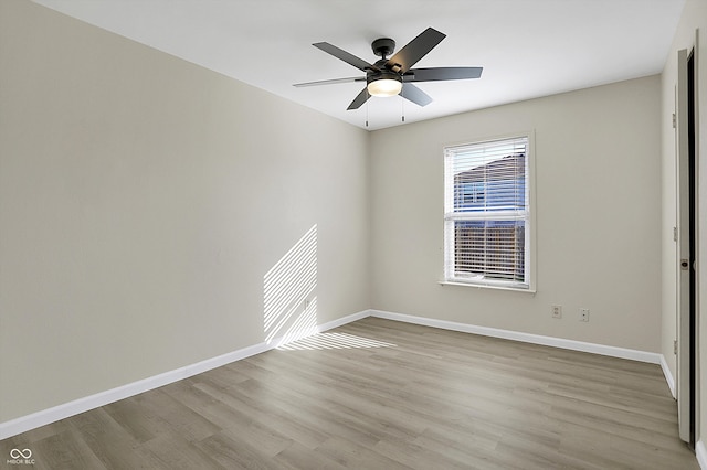 spare room featuring light hardwood / wood-style floors and ceiling fan