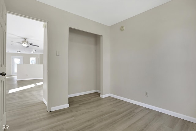 unfurnished bedroom with a closet and light wood-type flooring