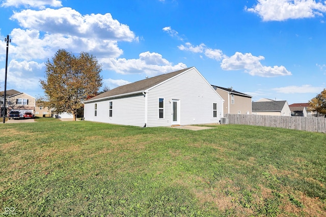 rear view of property featuring a patio area and a yard