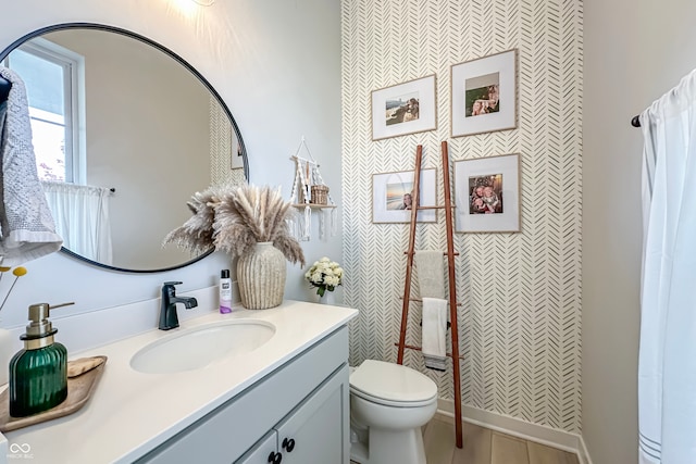 bathroom featuring vanity and toilet