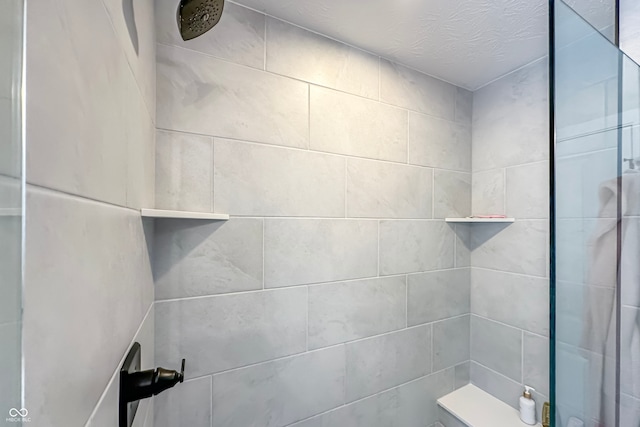 bathroom with tiled shower