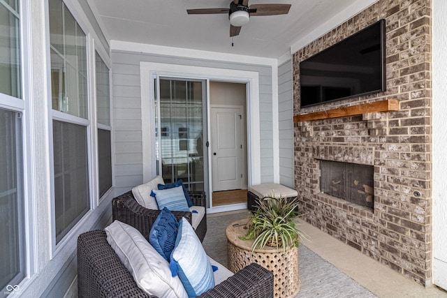 view of patio with an outdoor brick fireplace and ceiling fan