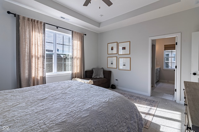 carpeted bedroom featuring ensuite bath and ceiling fan