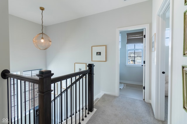 corridor with light colored carpet