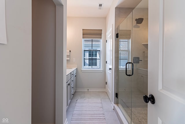 bathroom featuring vanity, walk in shower, and tile patterned floors