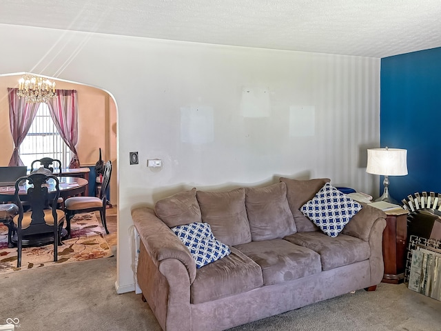 3305 N Keystone Ave, Indianapolis, IN 46218 - carpeted living area featuring a chandelier, arched walkways, and a textured ceiling