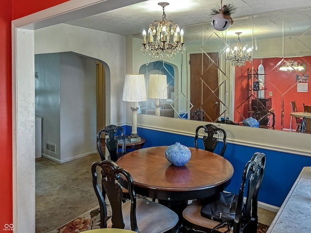 3305 N Keystone Ave, Indianapolis, IN 46218 - dining room featuring a chandelier, carpet, arched walkways, and a textured ceiling