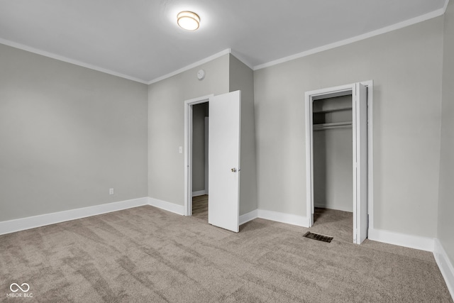 unfurnished bedroom featuring ornamental molding, a closet, and carpet floors