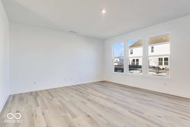 empty room with light hardwood / wood-style floors