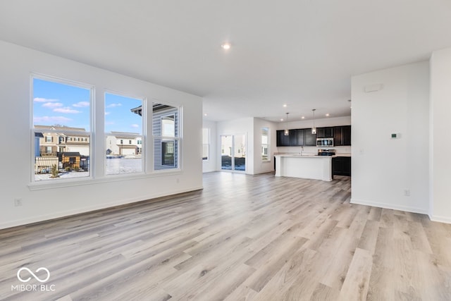 unfurnished living room with light wood-type flooring