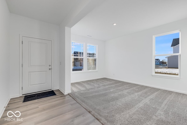 foyer entrance featuring light hardwood / wood-style flooring and a wealth of natural light