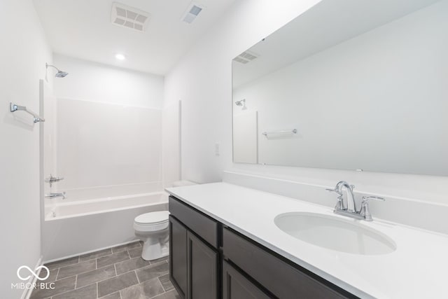 full bathroom featuring vanity, washtub / shower combination, and toilet