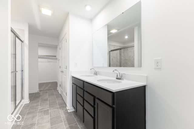 bathroom with walk in shower and vanity