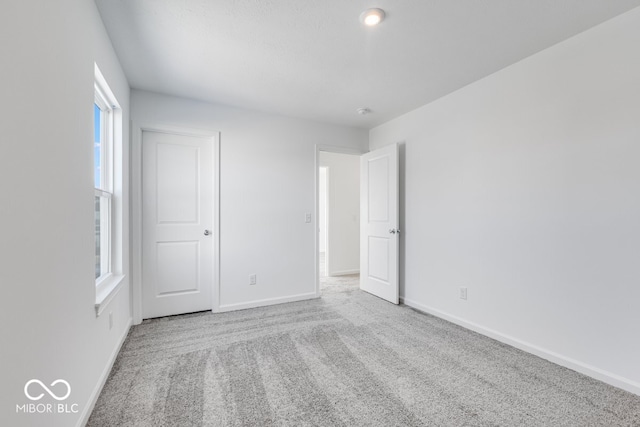 unfurnished bedroom featuring light colored carpet