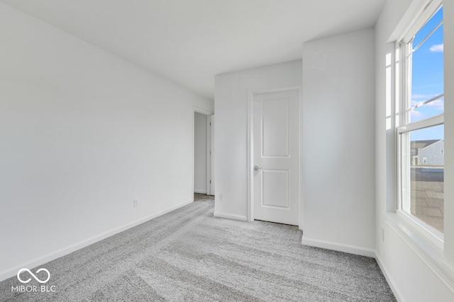 empty room featuring light colored carpet