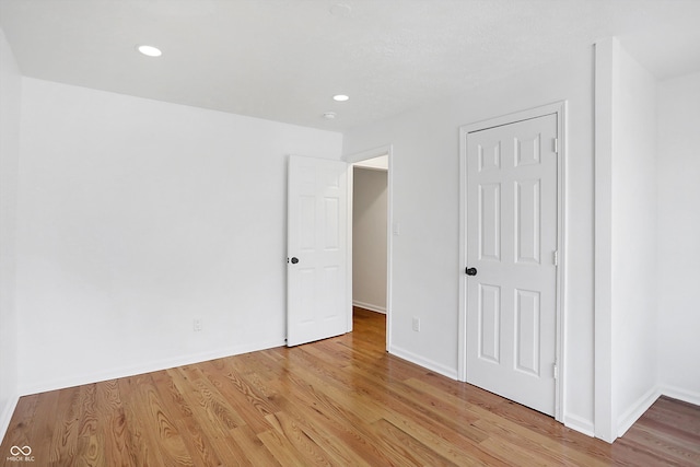 unfurnished bedroom with light wood-type flooring