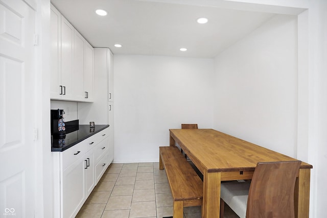 kitchen featuring white cabinetry and light tile patterned flooring