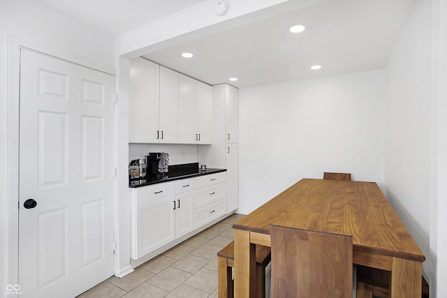 kitchen with light tile patterned flooring and white cabinets