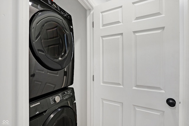 laundry room featuring stacked washer and clothes dryer