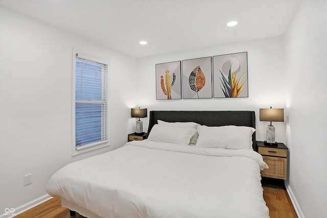 bedroom with dark hardwood / wood-style floors