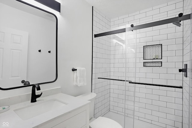 bathroom featuring vanity, toilet, and walk in shower