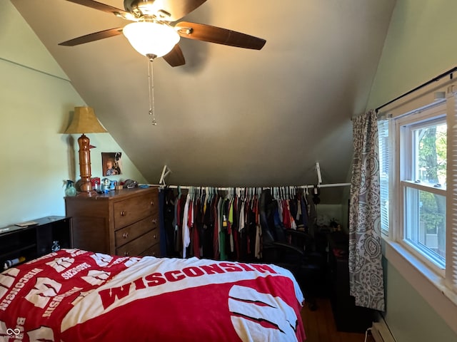 bedroom featuring ceiling fan, hardwood / wood-style flooring, and vaulted ceiling