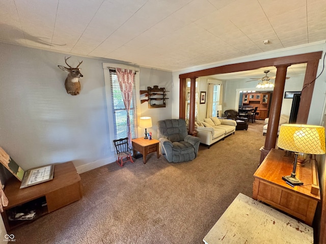 living room featuring ornamental molding, carpet floors, and ceiling fan