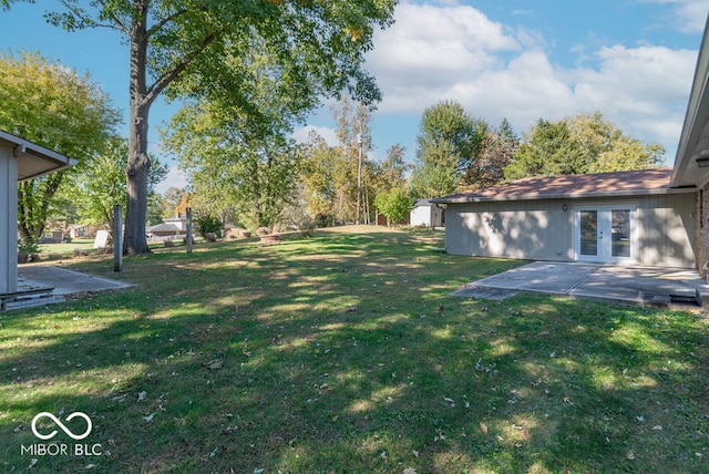 view of yard with french doors and a patio