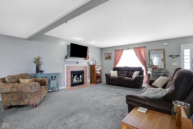 carpeted living room featuring a fireplace, a wealth of natural light, and a textured ceiling