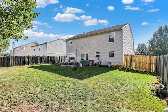 rear view of property with a patio and a yard