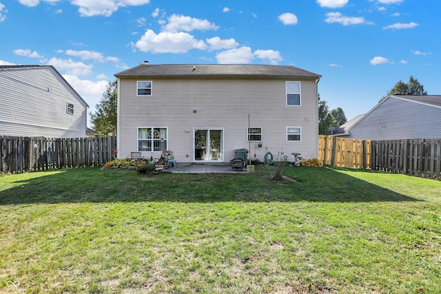 back of house with a patio and a yard