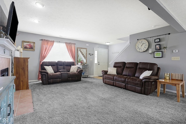 carpeted living room featuring a textured ceiling