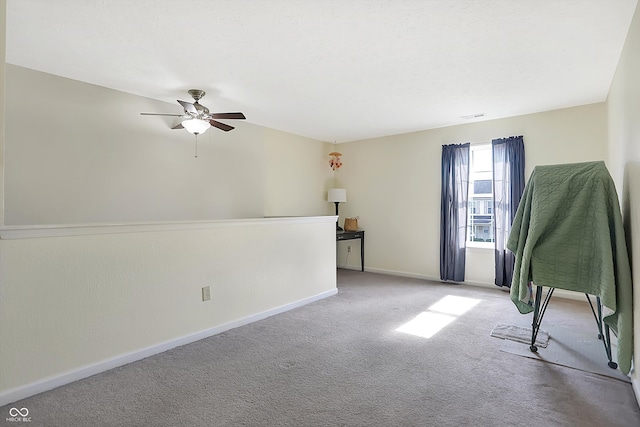 spare room featuring light colored carpet and ceiling fan