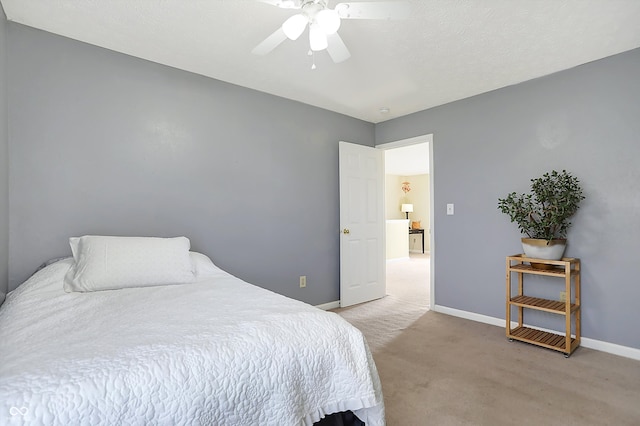 bedroom with ceiling fan and light carpet