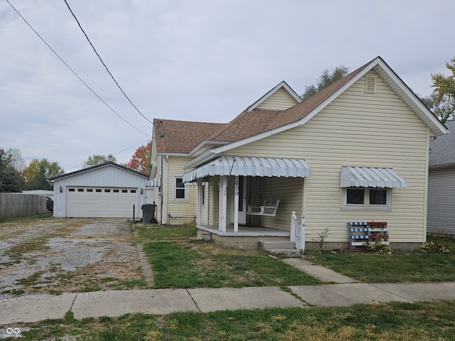 bungalow-style home with an outbuilding, a garage, and covered porch