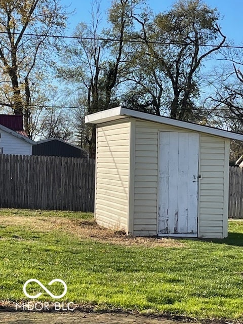 view of outbuilding featuring a lawn