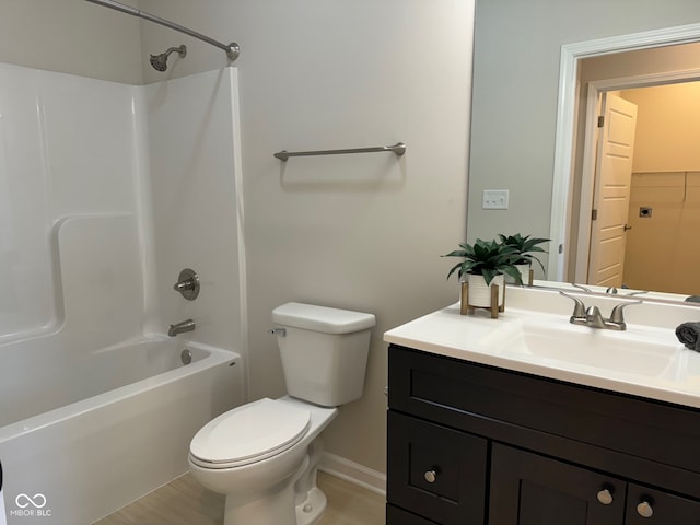 full bathroom with hardwood / wood-style flooring, vanity, shower / bathtub combination, and toilet