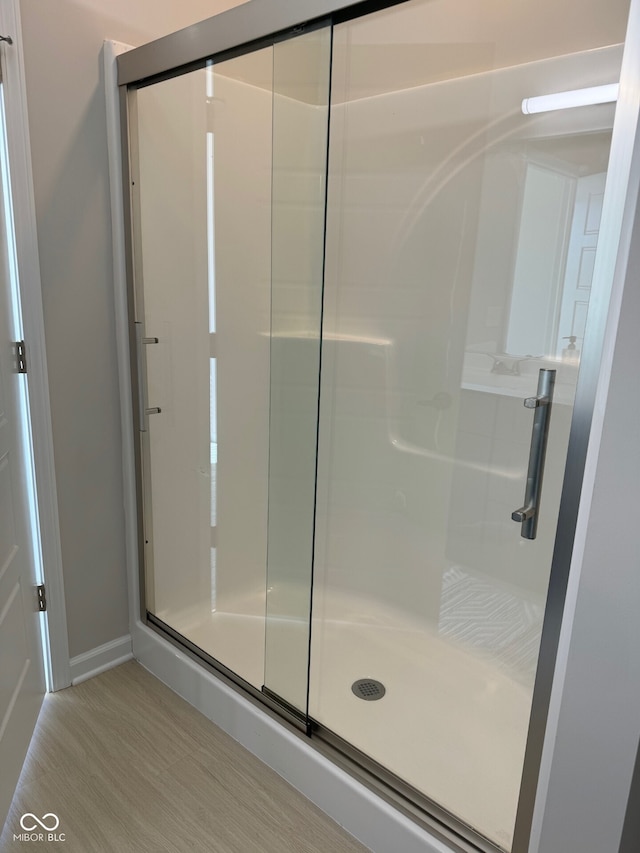 bathroom featuring a shower with door