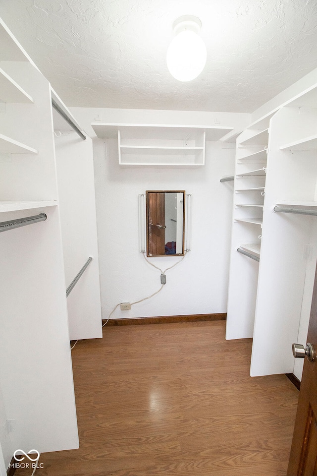 spacious closet featuring hardwood / wood-style flooring