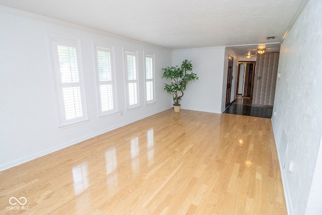 unfurnished room with light hardwood / wood-style flooring and ornamental molding