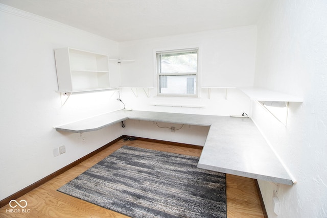 interior space featuring built in desk and dark hardwood / wood-style flooring