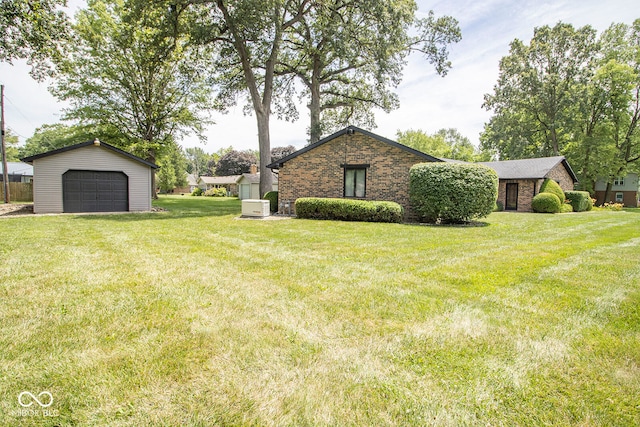 view of yard featuring an outdoor structure and a garage