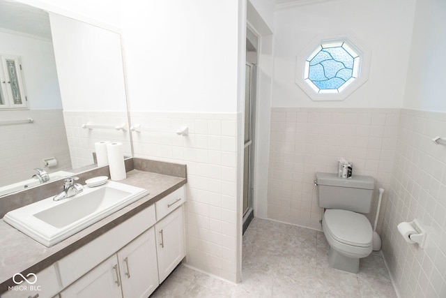 bathroom with vanity, tile walls, and toilet