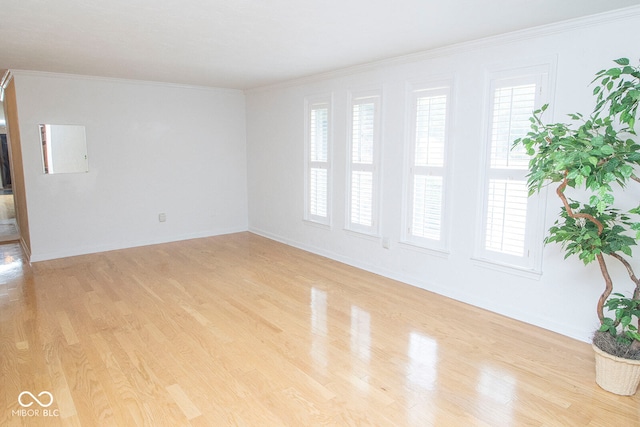 unfurnished room featuring crown molding and light hardwood / wood-style flooring