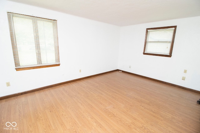 unfurnished room with wood-type flooring