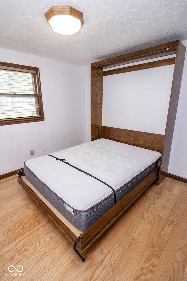 bedroom with hardwood / wood-style flooring