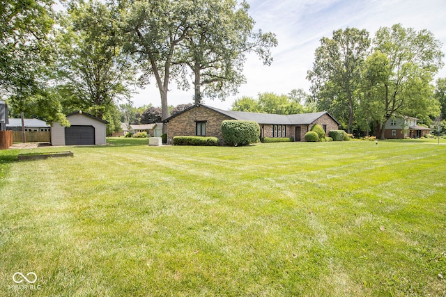 view of yard featuring a garage and an outbuilding