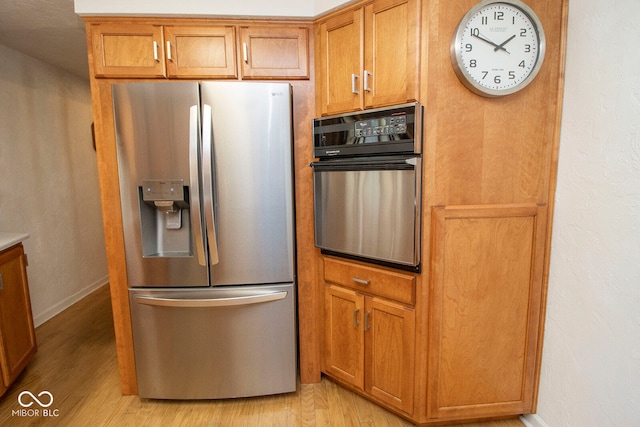 kitchen featuring appliances with stainless steel finishes and light wood-type flooring